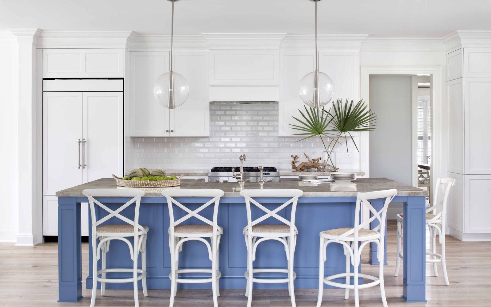 Coastal kitchen with a blue island in a Riomar beachside home